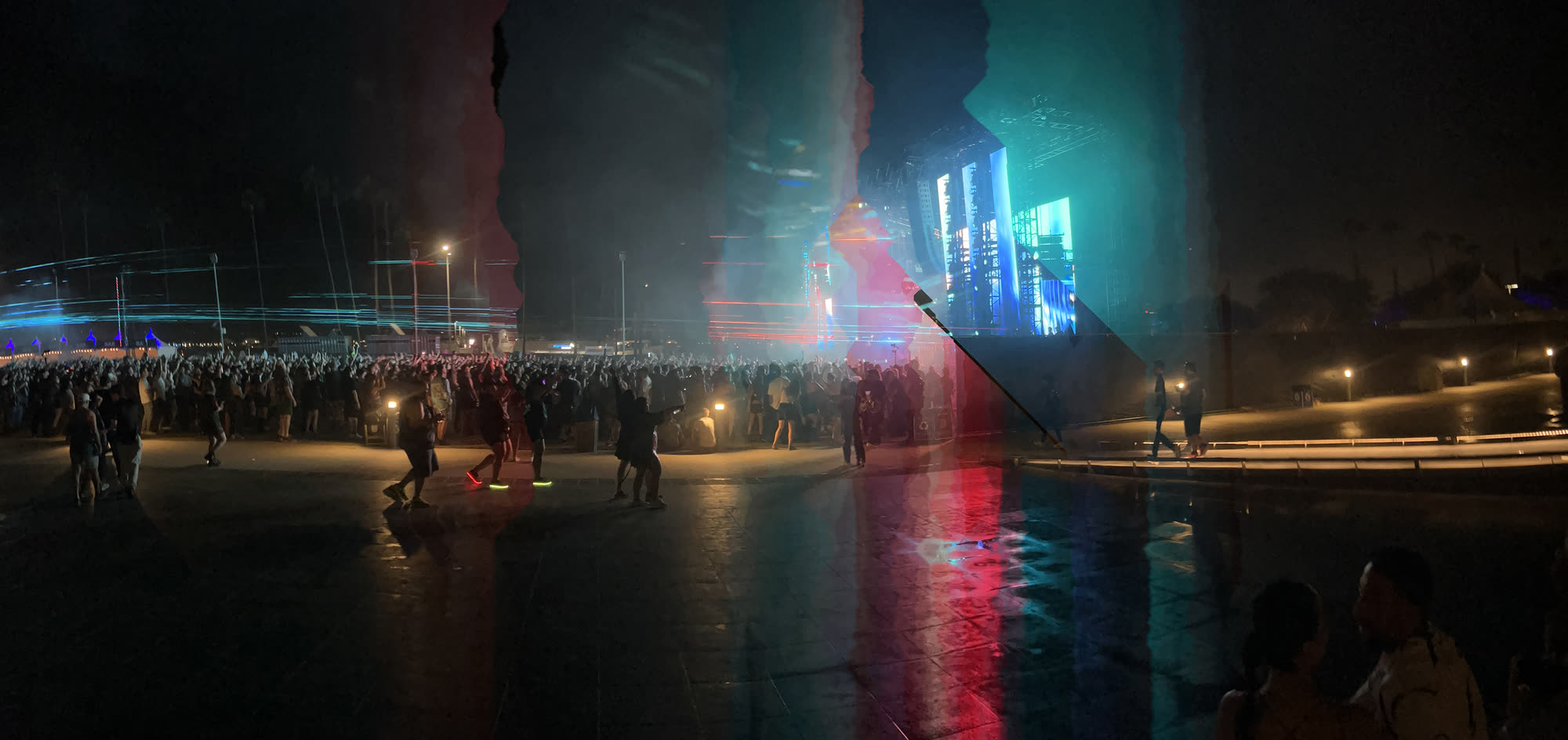 A stage lit in red and teal, with a hard diagonal shear running through the structure where two lighting states meet in the same frame.